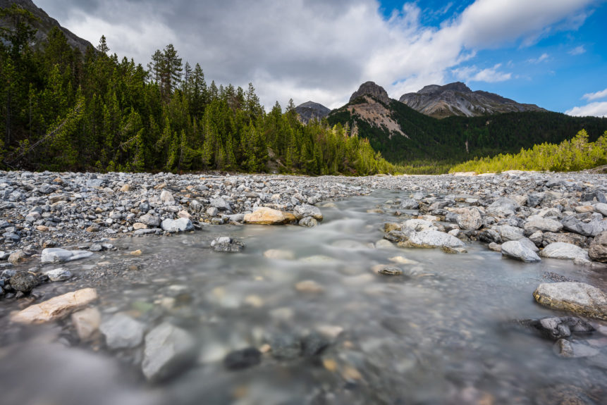 A mountain landscape in the Swiss National park, featuring a mountain river meandering down from the Swiss Alps. Down the River - Copyright Johan Peijnenburg - NiO Photography