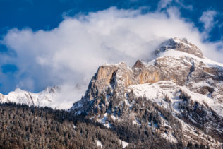 A winter mountain landscape near Gsteig in the Swiss Alps, with snow and clearing fog above an alpine forest and the Spitzhorn. Unveiled - Copyright Johan Peijnenburg - NiO Photography