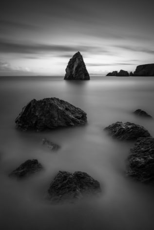 An Irish coastal landscape in B&W, featuring the rocks and sea stacks of Ballydowane Cove at the Celtic Sea in County Waterford, Ireland. The Cove - Copyright Johan Peijnenburg - NiO Photography