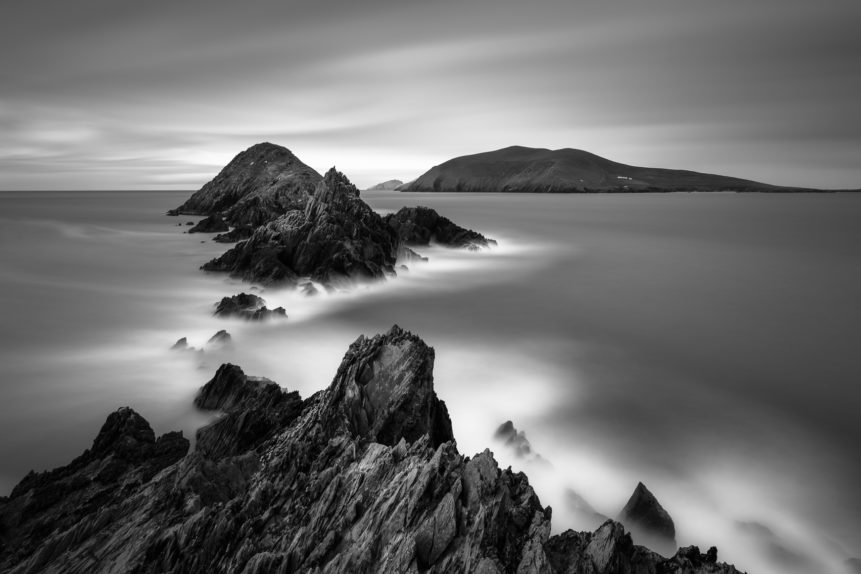 A black & white coastal landscape with rugged cliffs, the Blasket Islands and the Irish North Atlantic coast near Dingle in Kerry, Ireland. The Wild Atlantic - Copyright Johan Peijnenburg - NiO Photography