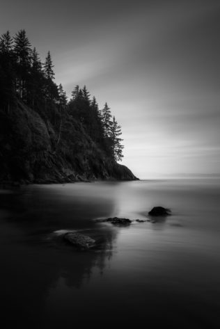 Sunrise at China Beach on Vancouver Island with trees reflected in the water of the North Pacific Ocean and wet sand of the beach. Rise & Shine - Copyright Johan Peijnenburg - NiO Photography