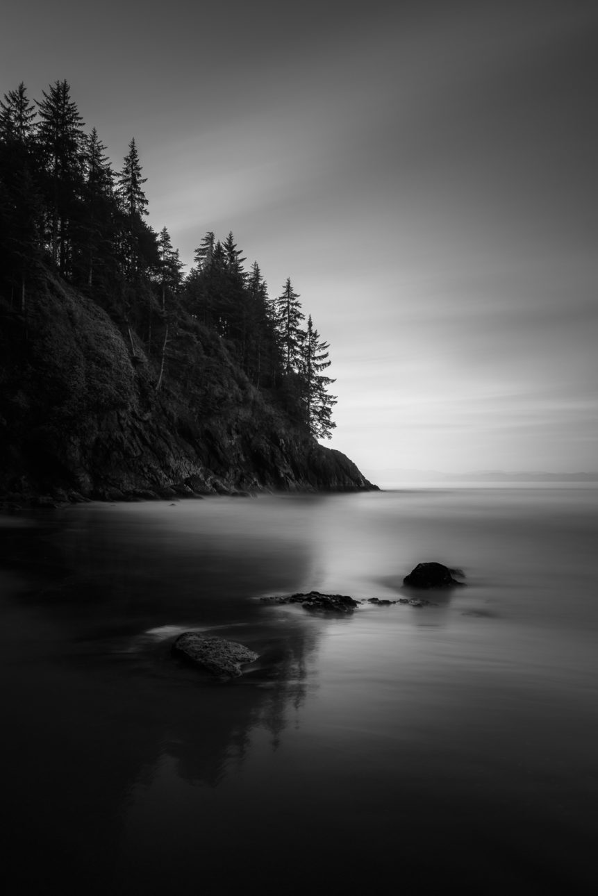 Sunrise at China Beach on Vancouver Island with trees reflected in the water of the North Pacific Ocean and wet sand of the beach. Rise & Shine - Copyright Johan Peijnenburg - NiO Photography