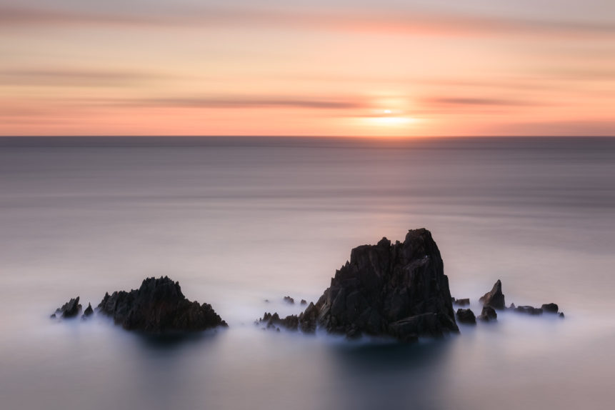 Cliffs and a colourful sunset at the Irish coast of the North Atlantic Ocean near Slea Head in Dingle, County Kerry, Ireland. Staring at the Sun - Copyright Johan Peijnenburg - NiO Photography