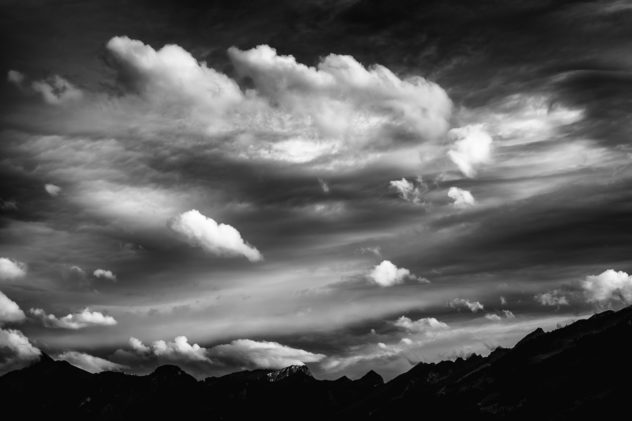 A cloudy sky above the Alps surrounding the Bas-Intyamon valley in  Switzerland, in black and white. Clouds in black & White - Copyright Johan Peijnenburg - NiO Photography