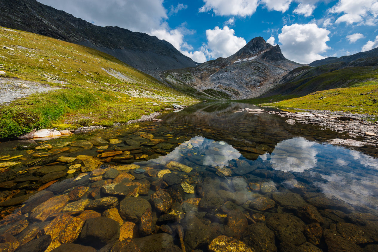 A crystal clear mountain lake on a sunny summer day with the Point de Drône in the background. This small lake is one of a group of lakes called Lacs de Fenêtre. Crystal clear - Copyright Johan Peijnenburg - NiO Photography