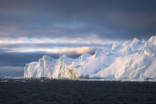 An Acrtic coastal landscape in colour, showing an iceberg warmed by sunset in the Icefjord near Disko Bay in Greenland. Frosty Sunset - Copyright Johan Peijnenburg - NiO Photography