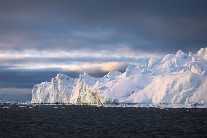 An Acrtic coastal landscape in colour, showing an iceberg warmed by sunset in the Icefjord near Disko Bay in Greenland. Frosty Sunset - Copyright Johan Peijnenburg - NiO Photography