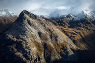 A landscape, featuring the Swiss Alps of Engadin with first autumn snow and snow-dusted mountains peaks bathing in the morning light. In Thin Air - Copyright Johan Peijnenburg - NiO Photography