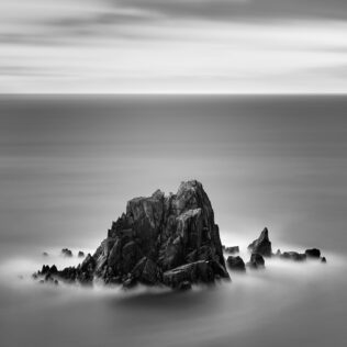 An Irish coastal landscape in B&W, featuring a seagull and rugged pointy cliffs in the North Atlantic Ocean near Slea Head on the Dingle peninsula in Kerry, Ireland. To the Point - Copyright Johan Peijnenburg - NiO Photography