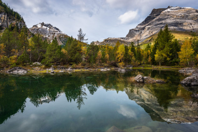 Fall colours and reflections at Lac Bleu in Derborence, with the mountains Les Diablerets and Tête à Pierre Grept in the background. Lac Bleu in Autumn - Copyright Johan Peijnenburg - NiO Photography