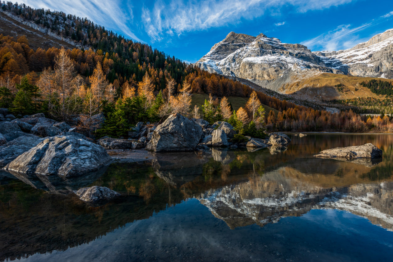 Les Diablerets mountain and trees with fall colours reflected in Lac de Derborence in Switzerland. Lac de Derborence - Copyright Johan Peijnenburg - NiO Photography