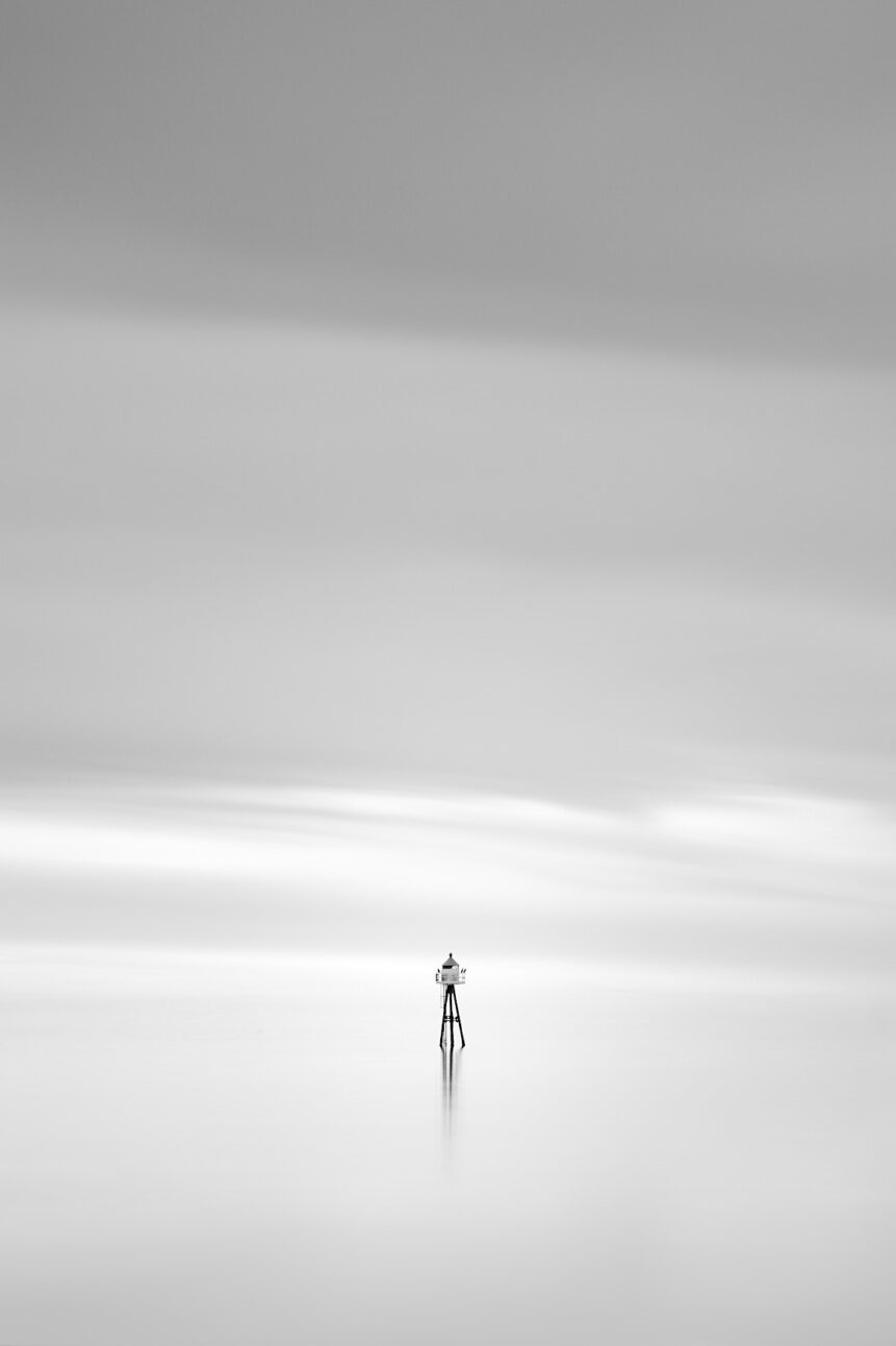 Two birds overlooking a calm Norwegian Sea near Lofoten from a small lighthouse, in a dreamy and soothing minimalist coastal landscape in black & white. Soothing - Copyright Johan Peijnenburg - NiO Photography