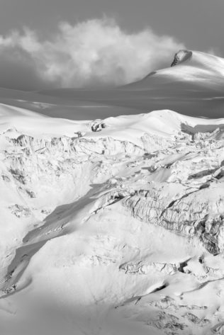 A mountain landscape in B&W, featuring the Moiry glacier with soft sunset light on the glacial snow and ice as well as Les Bouquetins mountain. Wall of Snow - Copyright Johan Peijnenburg - NiO Photography