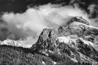 The Swiss Alps near Gsteig in B&W, with clearing fog above Spitzhorn mountain and an alpine forest in winter. Just Breathe - Copyright Johan Peijnenburg - NiO Photography