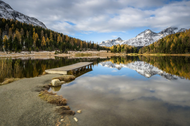 A lake landscape, showing an soothing autumn sunrise at Lej da Staz (Stazersee) in St. Moritz with fall colours and fresh snow on the Swiss Alps. Morning Glory - Copyright Johan Peijnenburg - NiO Photography