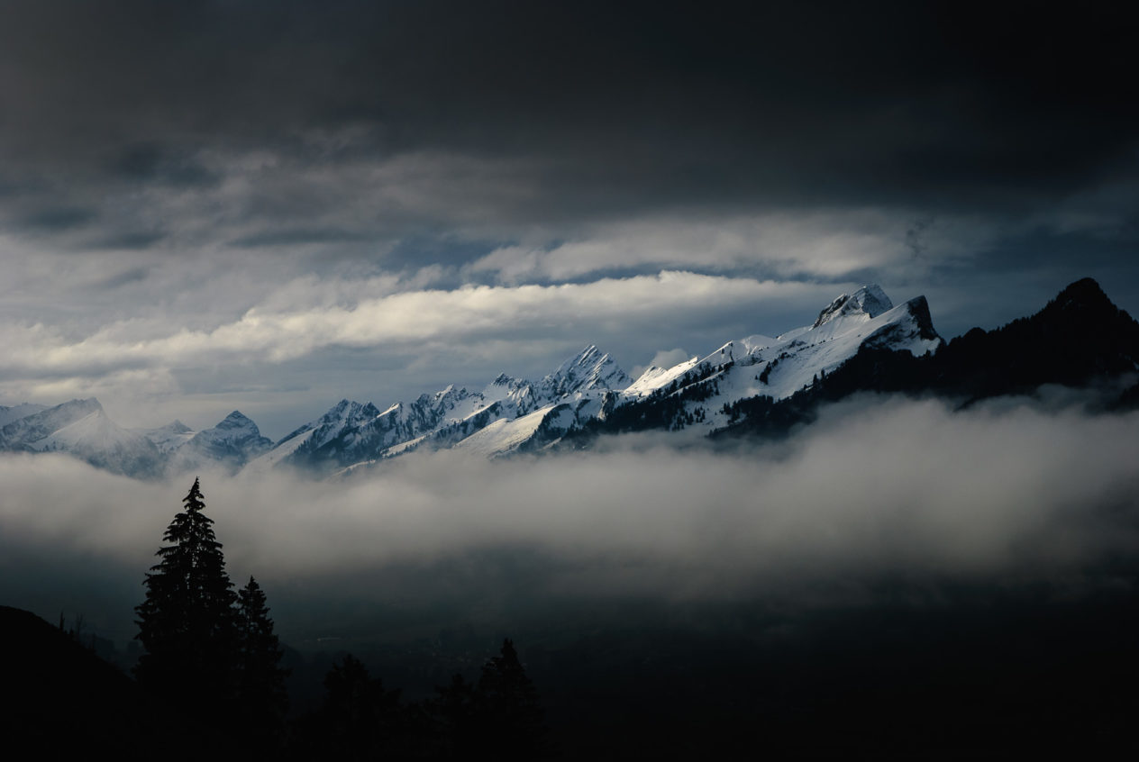 Aerial view on the Gruyère valley and the Swiss Alps in winter time, just before a thunderstorm. Brewing alpine storm - Copyright Johan Peijnenburg - NiO Photography