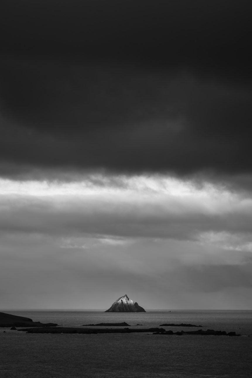 An Irish coastal landscape in B&W with first light on Tearaght Island, one of the Blaskets near the Dingle Peninsula in Ireland. A Touch of Light - Copyright Johan Peijnenburg - NiO Photography