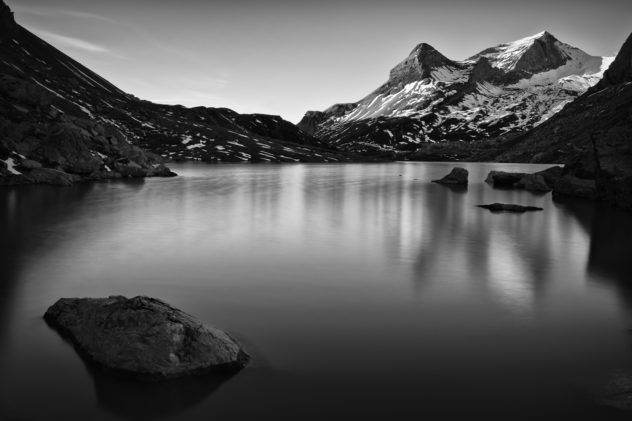 A landscape in black & white showing Lac de Sanetsch at sunrise with the Sanetschhorn mountain in the background. Lac Sanetch in black & white - Copyright Johan Peijnenburg - NiO Photography